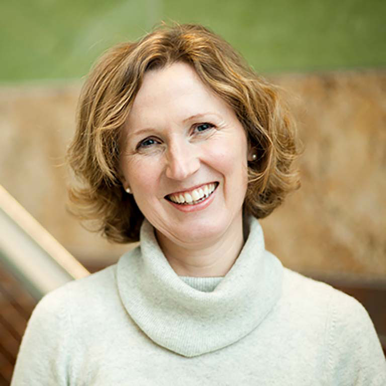 A headshot of Anke Birkenmaier, who wears a beige turtleneck sweater.